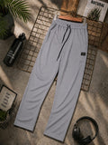 Men’s light grey jogger trousers with elastic waistband, adjustable drawstring and side pockets