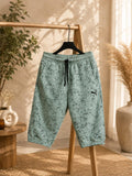 Men’s mint green printed shorts with a relaxed fit, elastic waistband, adjustable drawstring, side pockets, and stylish all-over textured print. A versatile choice for casual wear, summer outfits, everyday comfort, loungewear, and streetwear fashion.