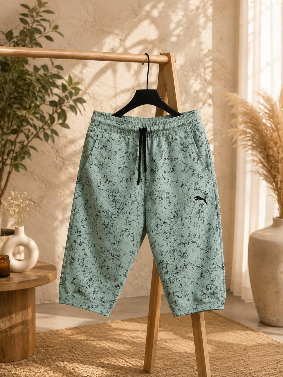 Men’s mint green printed shorts with a relaxed fit, elastic waistband, adjustable drawstring, side pockets, and stylish all-over textured print. A versatile choice for casual wear, summer outfits, everyday comfort, loungewear, and streetwear fashion.